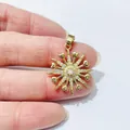 Detail of starburst pendant in gold finish with center zircon and heart-shaped elements - Star Heart Style