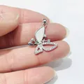 Macro detail of silver butterfly pendant with white shell inlay and zircon accents - Silver Style 4