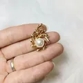 Detailed view of a gold spiral pendant with a large white pearl and zircon accents - Spiral Vortex Style (Gold No. 1)
