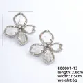 Elegant silver four-leaf flower earrings with sparkling cubic zirconia and crystal details - Silver and White Crystal (E00001-13)