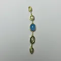 Close-up of a gold tassel pendant featuring a blue oval stone and sparkling zircon accents - Blue (Gold 5)