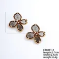 French luxury floral stud earrings in smoky gray petals with golden wavy frames - Gold and Inky Black (E00001-7)
