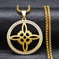 Detailed close-up of golden gothic knot pendant with sparkling crystals on a box chain - White Zirconia / Gold