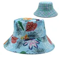 Detail of reversible sun hat showing tropical leaf print and classic plaid pattern - Light Blue Tropical Leaf with Blue Green Plaid (Style 3)
