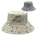 Close-up of reversible sun hat with pink floral patterns and classic grey plaid design - Pale Yellow Floral with Gray White Black Plaid (Style 6)