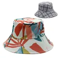 Detail of reversible bucket hat showing tropical leaf prints and classic plaid pattern - Tropical Plant Leaf with Black Gray White Plaid (Style 12)