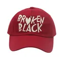 Detail view of white Broken Black embroidery and heart pattern on red cotton baseball cap - Adjustable / Red