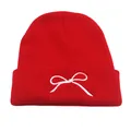 Red knit beanie with white bow embroidery for men and women, perfect for winter warmth - One Size / Red