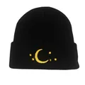 Black knit beanie with yellow moon and stars embroidery on a cuffed winter hat - Black