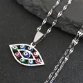 Macro detail of silver evil eye pendant with colorful beads on a dark stone background - Water Wave Chain Style / Silver