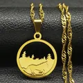 Detail of a gold layered necklace with a round forest and horse pendant on a black base - Running Horse Forest Style / Gold