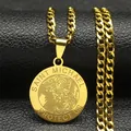Macro shot of gold Saint Michael pendant with Cuban link chain on black leather - Gold