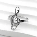 Close-up of polished silver treble clef music note ring with adjustable open band - Silver