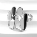 Macro shot of silver hollow-carved cat paw ring on a white textured background - Silver