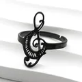 Macro detail of a black treble clef music note ring with adjustable open band design - Black