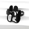 Macro shot of black animal paw ring featuring hollowed cat and dog silhouette details - Black