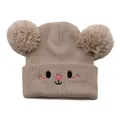 Detail of beige knitted baby beanie with dual pom-poms and cute cartoon face embroidery - One Size / Beige