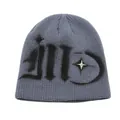 Detailed macro view of grey ribbed knit beanie with gothic lettering and metal star stud - One Size / Gray