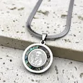 Macro detail of St. Benedict pendant with iridescent abalone shell inlay on silver snake chain - Silver