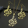 Exquisite gold music note jewelry set featuring treble clef and stave on dark stone - Gold Necklace Earrings Combination