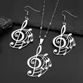 Silver musical G-clef note jewelry set with necklace and earrings on slate background - Silver Necklace Earrings Combination