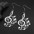 Macro shot of silver musical note earrings with treble clef design on dark stone - Silver Ear Hooks