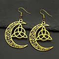 Detail of golden crescent moon earrings featuring a hollow Celtic Triquetra knot design - Gold Earrings