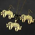 Golden stainless steel sloth jewelry set with necklace and earrings on black stone - Gold Set