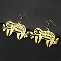 Detail of golden sloth earrings with MY SPIRIT animal text on black stone background - Gold Ear Hooks