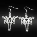 Macro detail of silver gothic skull heart earrings with wings on black reflective surface - Hook Earrings / Silver
