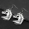 Detailed close-up of silver horse head drop earrings on a dark textured rock background - Earring Hooks / Silver