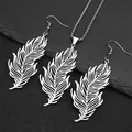 Detail of silver feather jewelry set with necklace and earrings on dark stone background - Silver Set