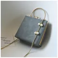 Detail of grey square crossbody bag with gold round handle and pearl chain accessory - Simple Version / Gray