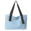 Light blue canvas tote bag with brown wide straps and casual typographic design - Blue