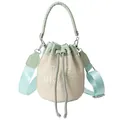 Light green and beige straw bucket bag with THE BUCKET embroidery and wide strap - Light Green