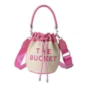 Pink and beige woven straw bucket bag with pink leather trim and THE BUCKET text - Rose Red