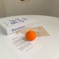 Realistic orange-shaped scented soy candle with citrus texture on a minimalist artistic background - Small Mandarin