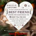 Macro detail of heart-shaped wooden plaque with friendship quote and rustic black string - Touching Quotes Theme (QT716-5)