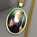 Macro shot of gold St. Benedict oval medallion pendant with saint portrait and chain - Gold