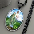 Close-up of black Saint Jude Thaddeus oval pendant with detailed religious art image - Black