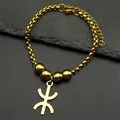 Macro detail of golden Amazigh symbol bracelet with round beads and lobster clasp - Gold