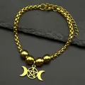 Macro view of golden stainless steel Triple Moon Goddess bracelet with pentagram charm - Gold