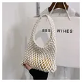 Detail of white handmade woven net bag featuring hollow mesh knots and a comfortable handle - White