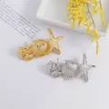 Detailed close-up of gold and silver sea star and shell hair clips for hair styling - Silver-Tone Shell & Starfish Style 1