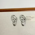 Detailed close-up of silver-tone biomimetic ear studs with liquid metal texture and stones - Style F Silver Flow (P-24)