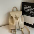 Minimalist beige leather mini backpack with gold buckle and drawstring closure - Off-white