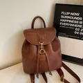Vintage brown leather backpack with gold metal buckle and drawstring closure for women - Brown