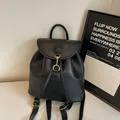 Minimalist black PU leather backpack for women with golden hook and drawstring closure - Black