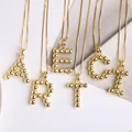 18K gold plated necklace featuring bubble beaded initial pendants on a box chain - Letter K