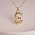 Detailed view of the 18K gold plated S-letter balloon pendant with rounded metal beads - Letter S